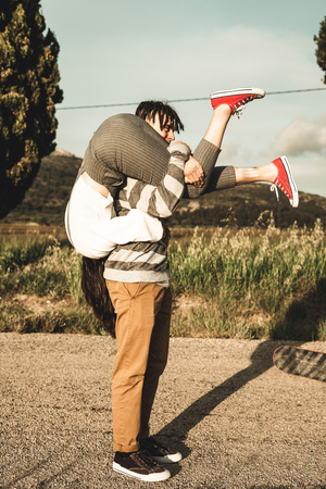 Portrait of a young couple of happy and funny lovers outdoors. Millennial peopleの写真素材