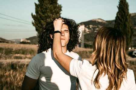 Handsome man smiling with long hair and curls. Happy Guy Conceptの写真素材