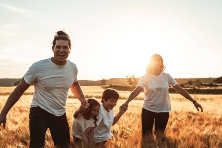 Happy and fun family in nature. Concept of united family having fun and smilingの写真素材