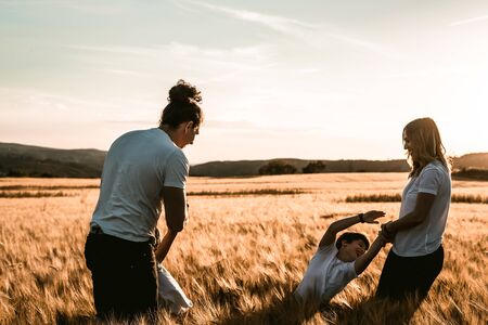 Portrait of a happy and fun family in the countryside. Concept of love familyの写真素材