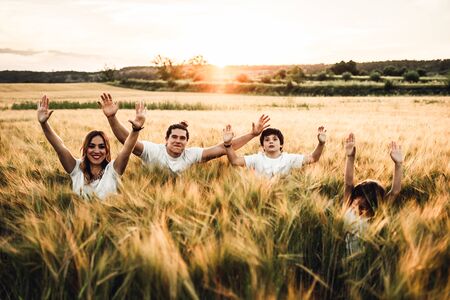Portrait of a happy and fun family in the countryside sunset. Concept of love family