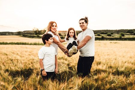 Happy family having fun in the countryside. Concept of a joyful and united familyの写真素材