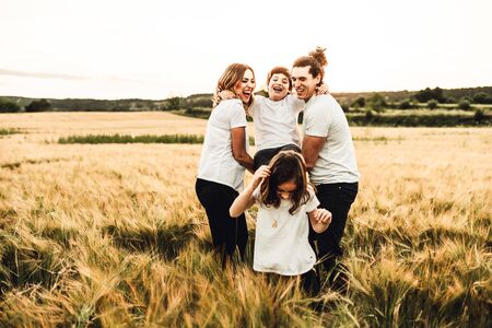 Portrait of a happy and beautiful family playing in the countryside. Concept of family having funの写真素材