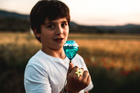 Kid playing spinning top.Concept of happy playing childrenの写真素材