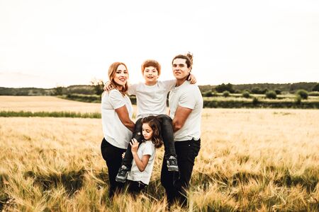 Portrait of a happy and beautiful family playing in the countryside. Concept of family having funの写真素材