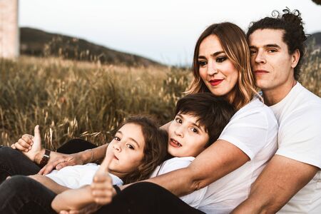 Portrait of a happy and funny young family outdoors.Family lifestyle conceptの写真素材