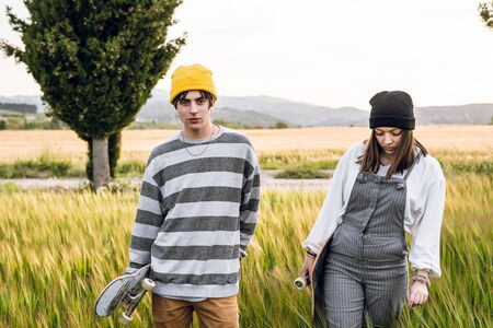Young couple with casual style riding a skateboard. Young urban lifestyle millennialの写真素材