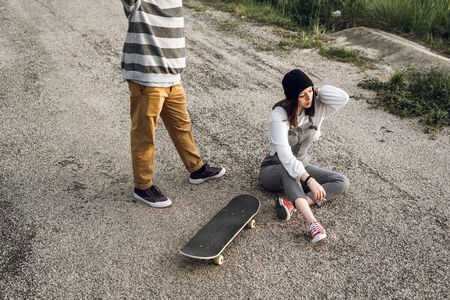 Young couple with casual style riding a skateboard. Young urban lifestyle millennialの写真素材