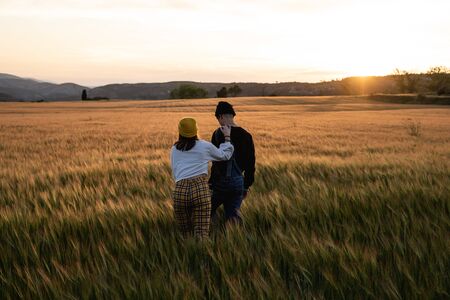 Young couple kissing and hugging at sunset. Concept millennial happy people in loveの写真素材
