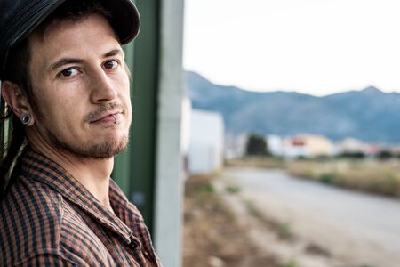 Portrait of handsome young modern guy happy on the street. Guy casual dress. Concept social networksの写真素材