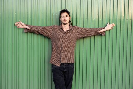 Portrait of handsome young modern guy happy on the street. Guy casual dress. Concept social networksの写真素材