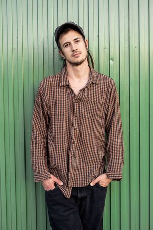 Portrait of handsome young modern guy happy on the street. Guy casual dress. Concept social networksの写真素材