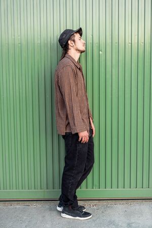 Portrait of handsome young modern guy happy on the street. Guy casual dress. Concept social networksの写真素材
