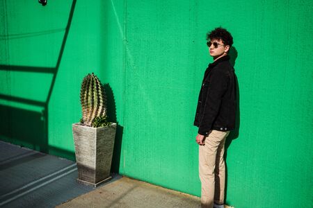 Portrait guy dressed modern in the street with sunglasses. Teenager Social Networking style photoの写真素材