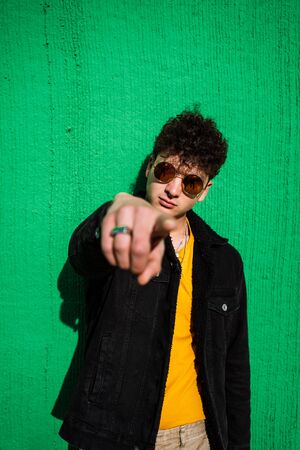 Portrait guy dressed modern in the street with sunglasses. Teenager Social Networking style photoの写真素材