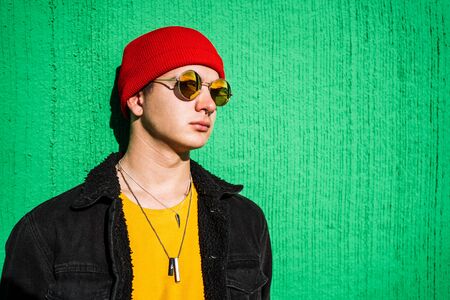 Guy with urban style hat and sunglasses. Portrait of a modern and casual lifestyle in the city