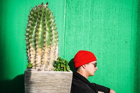 Guy with urban style hat and sunglasses. Portrait of a modern and casual lifestyle in the cityの写真素材