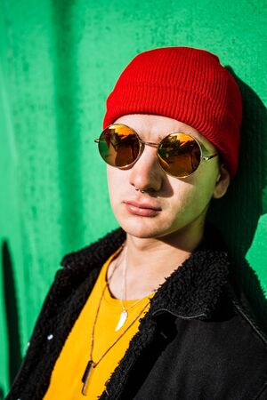 Guy with urban style hat and sunglasses. Portrait of a modern and casual lifestyle in the cityの写真素材