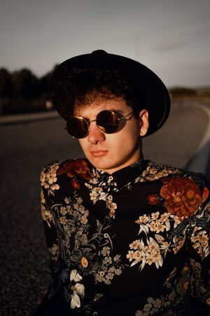 Portrait of a stylish modern guy on the road. Concept of young lifestyleの写真素材