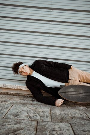 Portrait guy with a skateboard. Modern skater conceptの写真素材
