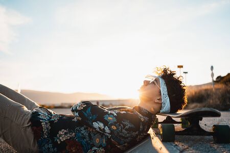 Young Man Longboarding in the Street. Guy skateboardの写真素材