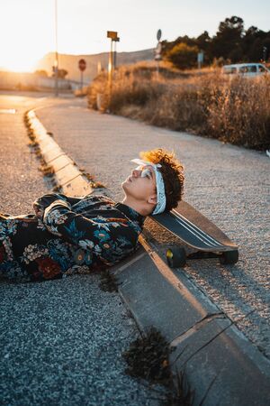 Young Man Longboarding in the Street. Guy skateboardの写真素材