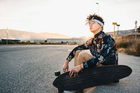 Young Man Longboarding in the Street. Guy skateboardの写真素材