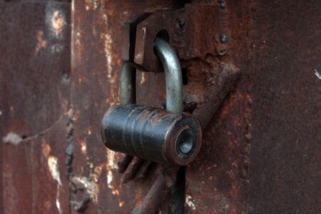 close up large metal rusted garage doors locked.