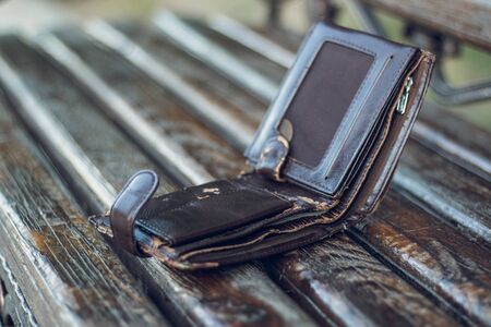 Left a very old pocket cash wallet on a wooden bench in urban public park. Lost personal thing in...