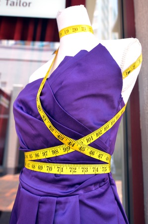 Tailors purple textile dress dummy with measure tape.の写真素材