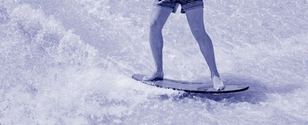Man ride a surfing board 	Man ride a surfing board on FlowRider. BWの写真素材