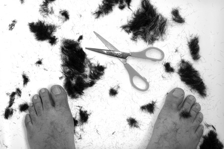 Trimmed hair on the floor with scissors.の写真素材