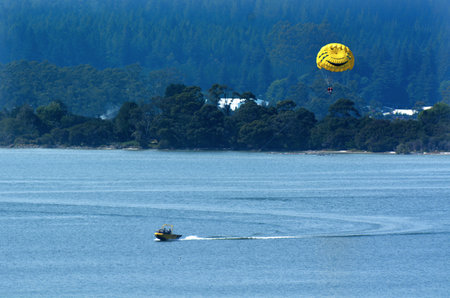 ROTORUA, NZL - JAN 15 2015:Parasailing over lake Rotorua New Zealand.In 2013, the first ASTM parasail weather standard was approved in bringing the unregulated industry into uniformed and safety.のeditorial素材