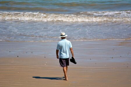 Retired man walks on the beach. concept photo retirement