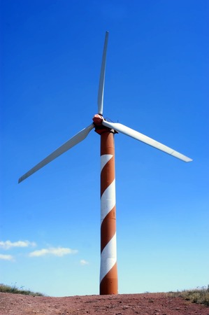 Wind power station - wind turbine against blue sky.の写真素材