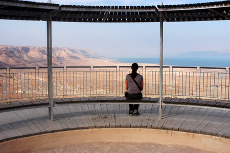 Tourist looks at the landscape of the Dead sea valley from Masada Fortress, Israelのeditorial素材
