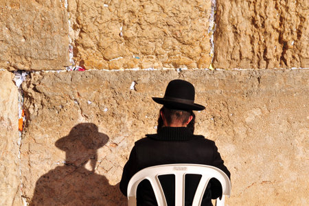 A  Jewish orthodox man prays at the Western Wall in the old city of Jerusalem Israelのeditorial素材