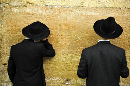 Jewish Men are praying at the western wall in the old city in Jerusalem Israelの写真素材