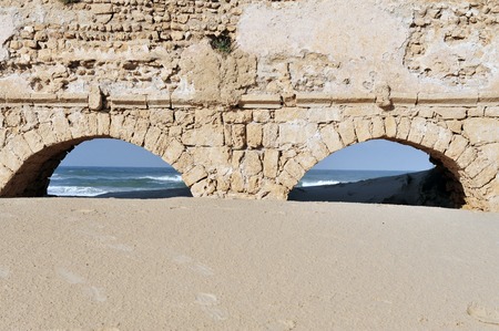 Ancient Roman aqueduct at Ceasarea along the coast of the Mediterranean Sea Israelの写真素材