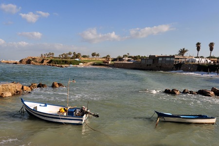 Fisherman boats in Caesarea ancient port on coast of Mediterranean sea in Israel.の写真素材