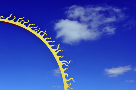 101122RBA09.JPG	Conceptual photo of a sun with the blue sky and puffy clouds in the backgroundの写真素材