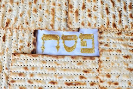 Traditional Jewish Matzo sheet on a Passover Seder table. Passover  is a predominantly Jewish holy day and festival. It commemorates the story of the Exodus, in which the ancient Israelites were freed from slavery in Egypt. Passover begins on the 15th dayの写真素材