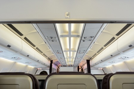Commercial passengers airplane interior of rows of chairsの写真素材
