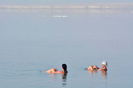 EIN BOKEK, ISR - APR 30 2015:Visitors in Ein Bokek resort at the Sead Sea, Israel.As the place is rich in sulphur, the water is believed to be beneficial to treatment of diseases and allergies.のeditorial素材