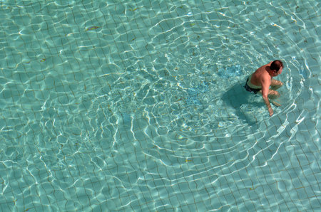 EIN BOKEK, ISR, APR 04 2015:Adult man in a pool.According to NCIPC, every day, about ten people die from unintentional drowning and nearly 80% of people who die from drowning are male.のeditorial素材