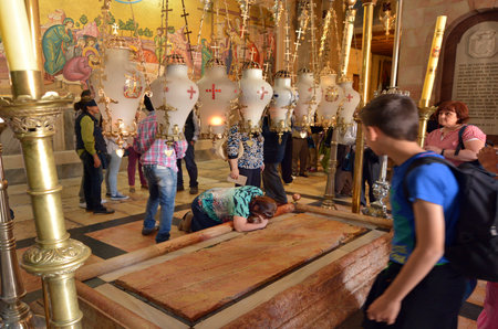 JERUSALEM, ISR - MAY 05 2015:Pilgrimspray on the Stone of Anointing at the Church of the Resurrection in Jerusalem, Israel. The Church considered to be the holiest Christian site in the world.のeditorial素材