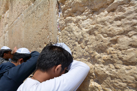 JERUSALEM, ISR - MAY 05 2015:Jewish men pray at the Western Wall of the Temple Mount. It's the holiest site in Judaism and is the place to which Jews turn during prayer.のeditorial素材