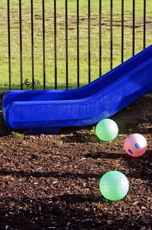 Slide and three balls in children playground.の写真素材