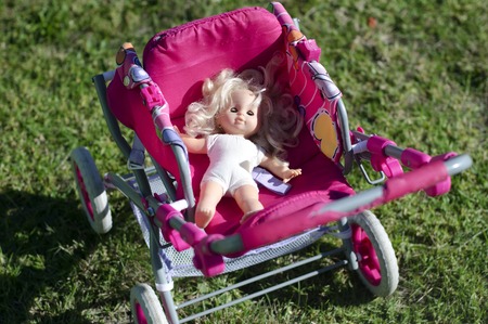 Blonde doll in a child carriage.の写真素材