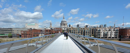 LONDON, UK - MAY 12 2015:Pedestrian cross over the Millennium Bridge in London, UK. It is London first dedicated pedestrian footbridgeのeditorial素材